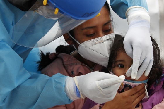Image: 2-year-old Regina Chavez is tested for Covid-19 in a tent set up to perform rapid testing at a bus station in Mexico City on Nov. 20, 2020.