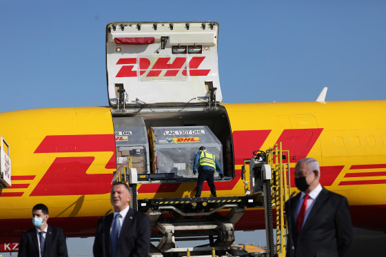 Image: Israeli Prime Minister Benjamin Netanyahu, right, and and his Health Minister Yuli Edelstein, center, attend the arrival of over 100,000 of doses of the Pfizer coronavirus vaccines at the Ben Gurion Airport near Tel Aviv, Israel