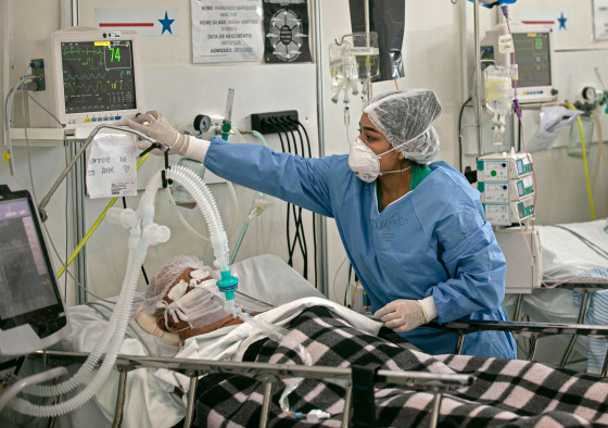 A medical worker assists a Covid-19 patient at a field hospital in Belem, Brazil on Dec. 3, 2020.