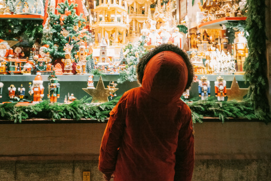 Little boy looking at store window on Christmas