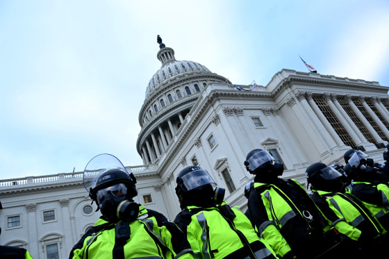 Image: Police stand guard as protesters gather near the Capitol on Jan. 6, 2021.