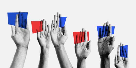 Photo illustration of raised handing holding blue and red cards