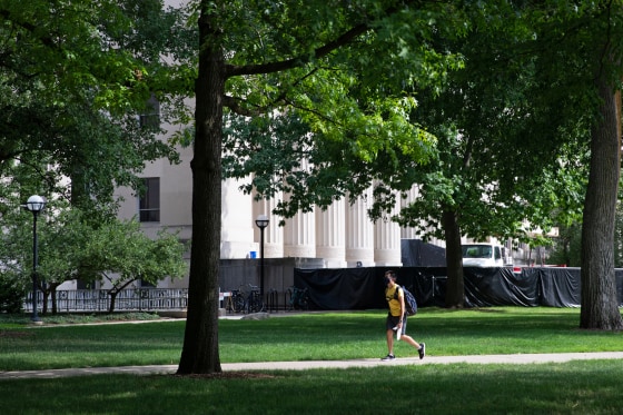 A student walks through the Diag on the University of Michigan campus in Ann Arbor