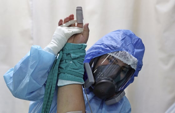 Image: A health worker treats a patient inside the Covid-19 ICU at Alberto Sabogal Hospital in Callao, Peru, on Jan. 11, 2021.