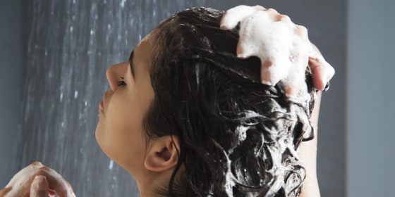 Woman washing her hair in shower