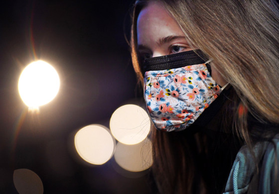 A woman wearing two facemasks, a cloth mask over a surgical mask, in Arlington, Va., on Fe. 8, 2021.