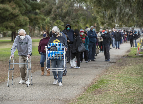 Seniors wait in long vaccine lines at Balboa Sports Complex in Encino