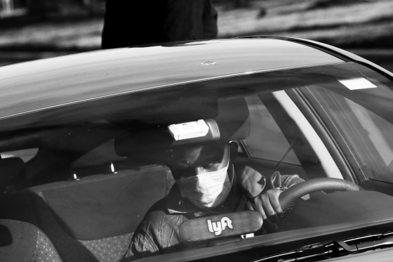 Image: A Lyft rideshare driver wears a mask in Washington