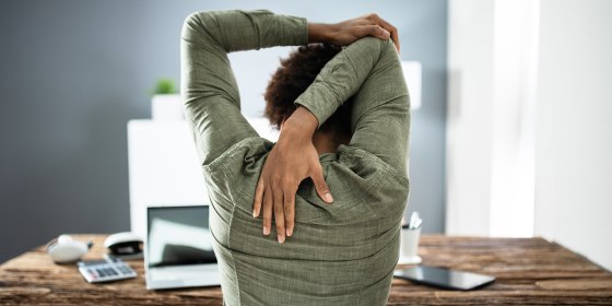 Rear View Of A Businessman Stretching His Arms