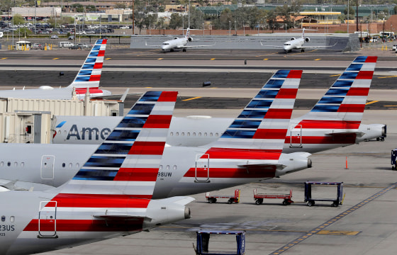 American Airlines jets sit at their gates at Sky Harbor International Airport in Phoenix on March 25, 2020.