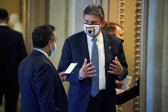 Senator Joe Manchin, D-W. Va., speaks to a reporter outside the Senate Chamber on Feb. 13, 2021.