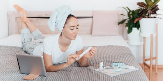 Woman doing her nails with different manicure tools and accessories