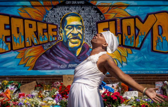 Image: A woman reacts at a memorial for George Floyd following a day of demonstration in a call for justice in Minneapolis