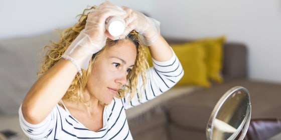 Woman dying her hair at home