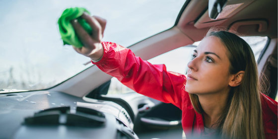 Woman spring cleaning the inside of her car