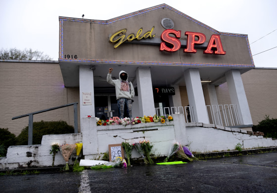 Image: Malik Peay stands in protest outside of Gold Spa in Atlanta, a day after three massage parlors were targeted by a shooter that left eight people dead, six of them Asian women.