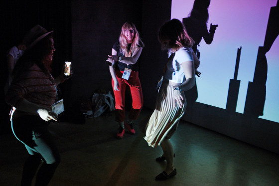 Attendees participate in an interactive light exhibit at the South by Southwest (SXSW) conference and festivals in Austin, Texas