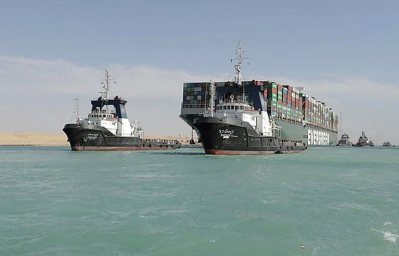 Image: A tugboat pulling the Panama-flagged MV 'Ever Given' container ship after it was fully dislodged from the banks of the Suez
