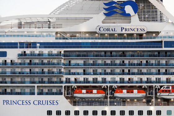 Passengers are seen aboard the Coral Princess ship as it docks at Miami Port, Fla. April 4, 2020.