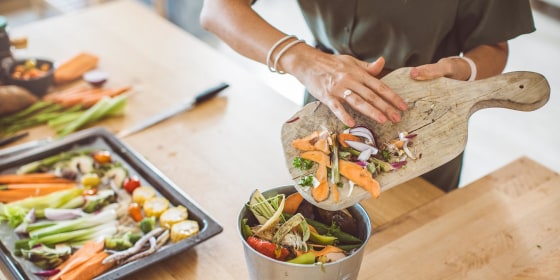 Woman making compost from vegetable leftovers