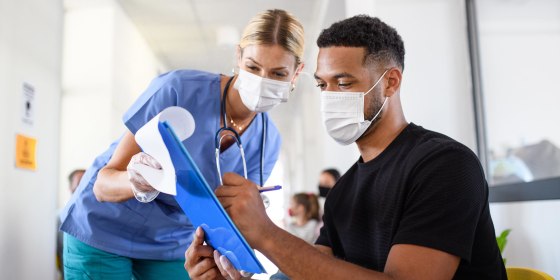 Nurse helping out a patient with paperwork