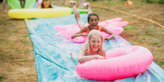 Children Having fun on a Slip 'n' Slide