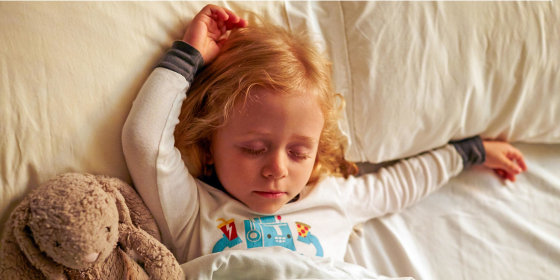 Young girl sleeping with stuffed rabbit