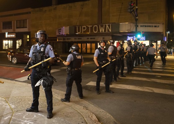 Minneapolis police officers stand in formation after a vigil for Winston Boogie Smith Jr. early on June 5, 2021.