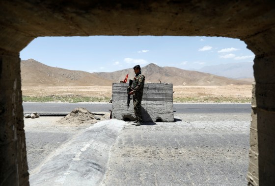 Image: Afghan National Army soldier stands guard at a check post near Bagram U.S. air base