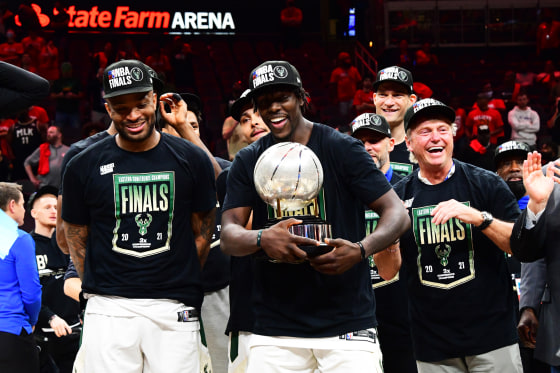 P.J. Tucker #17 of the Milwaukee Bucks and Jrue Holiday #21 celebrate with the Eastern Conference Finals Trophy after game 6 of the Eastern Conference Finals of the 2021 NBA Playoffs on July 3, 2021, in Atlanta.