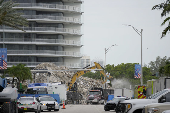 Image: An excavator removes the rubble of the demolished section of the Champlain Towers South building, as recovery work continues at the site of the partially collapsed condo building
