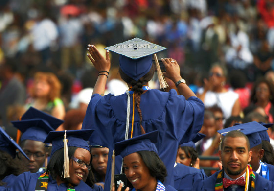 Image: A student waves to family members as she takes her seat for Howard University's commencement in Washington on May, 10, 2014.