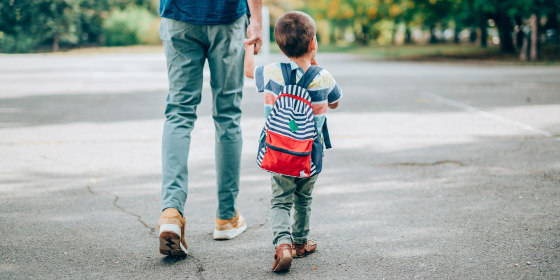 Father and son going to kindergarten
