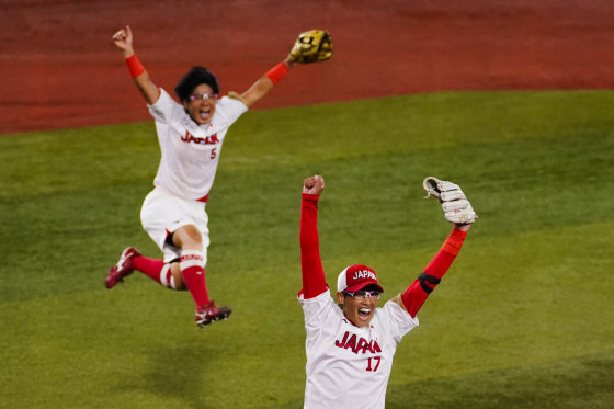 Japan's Yukiko Ueno, right, and Yu Yamamoto celebrate after winning softball game against the United States at the Olympics in Yokohama, Japan, on July 27, 2021.