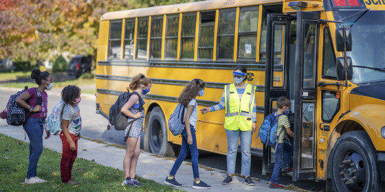 Students heading to school wearing masks