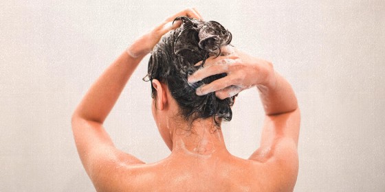 Woman Washing Hair In Bathroom At Home