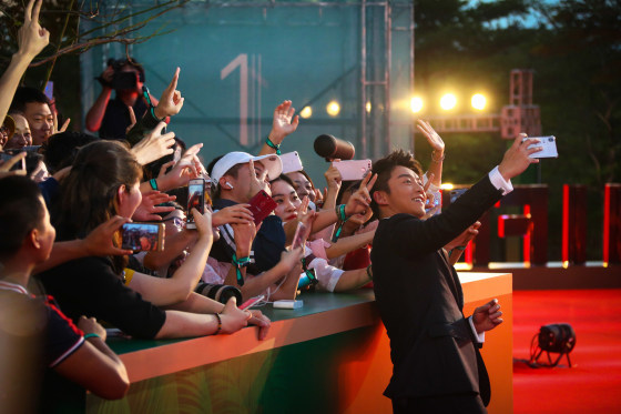 Actor Ryan Zheng Kai takes a selfie with fans on the red carpet during the opening ceremony of the 1st Hainan International Film Festival on Dec. 11, 2018, in Sanya, Hainan province, China.
