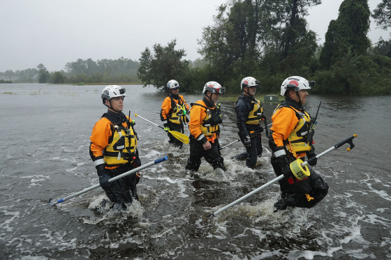 Image: Members of the FEMA Urban Search and Rescue Task Force 4 from Oakland, Calif., search a flooded neighborhood for evacuees during Hurricane Florence Sept. 14, 2018 in Fairfield Harbour, N.C.