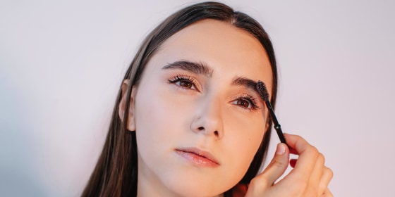 Woman brushing her eyebrows