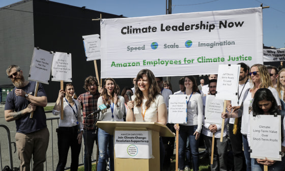 Emily Cunningham, center, who works as a user experience designer at Amazon.com, speaks during a news conference following Amazon's annual shareholders meeting on May 22, 2019, in Seattle held by the group \"Amazon Employees for Climate Justice.\"