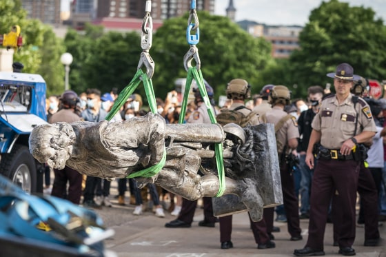 Image:  A tow truck removes the Christopher Columbus statue after it was toppled in front of the Minnesota State Capitol in St. Paul on June 10, 2020.