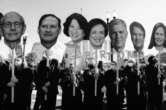 Image: Abortion rights advocates hold cutouts of the Supreme Court Justices as the court hears arguments in a Mississippi case where a 2018 law would ban abortions after 15 weeks of pregnancy on Dec. 1, 2021.