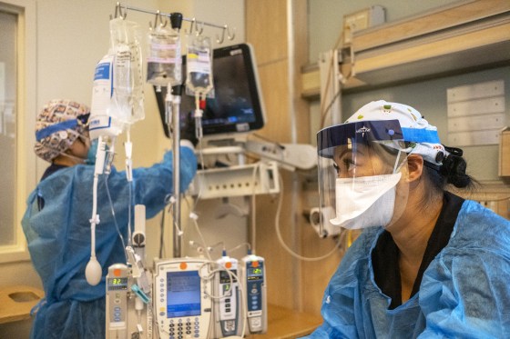 Medical staff help a Covid-19 patient in the ICU at Martin Luther King Jr. Community Hospital on Dec. 31, 2021, in Los Angeles.