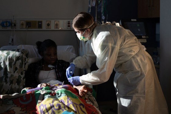 Image: A nurse treats a patient who has Covid-19 at the Children's Hospital of Georgia in Augusta, Ga., on Jan. 14, 2022.