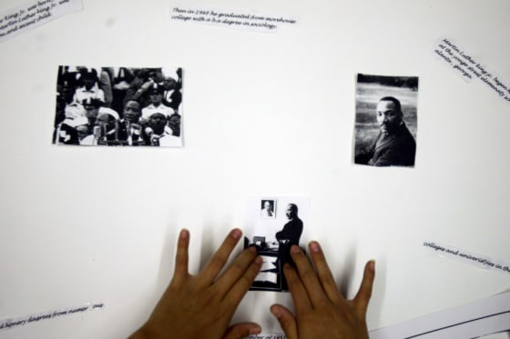Onamia MN, 2/25/04----Vala Eagle 11, a 6th grader at Nay Ah Shing school in Onamia puts photographs of Dr. Martin Luther King on a poster for Black History month. Donna Benson is a social studies teacher at Nay Ah Shing school and the students in he