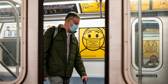 Image: Mass transit rider wearing a mask as they commute on the New York Subway.