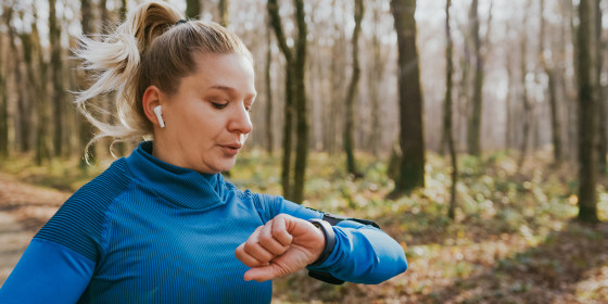 Female runner checking smartwatch while running