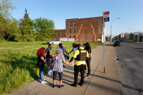 Image: People pray across the street from the Tops supermarket where 10 people were killed in a mass shooting in Buffalo, N.Y., on May 15, 2022.