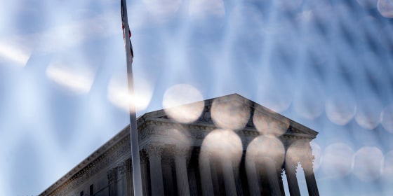 Image: Supreme Court seen through the temporary fencing around it.