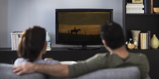 Rear view of couple watching tv, Jersey City, New Jersey, USA